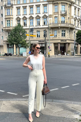 a lady in a white lace top and a pair of white pants